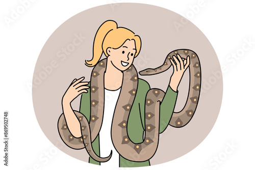 Woman with long snake around neck smiles enjoying communication with beloved pet boa constrictor. Girl holds dangerous predatory snake and does not feel fear at sight of poisonous python