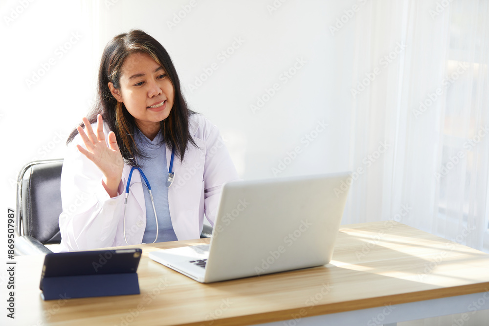 female doctor online video call and say hello to patient with laptop computer in the hospital female doctor online video call and say hello to patient with laptop computer in the hospital