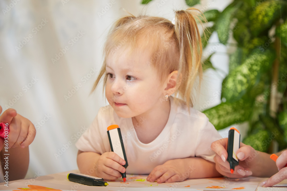 Cute little girl are painting on table. Preschooler, 4 years child in living room. Small girl kids doing homework, Nursery school Cute little girl are painting on table. Preschooler, 4 years child in living room. Small girl kids doing homework, Nursery school