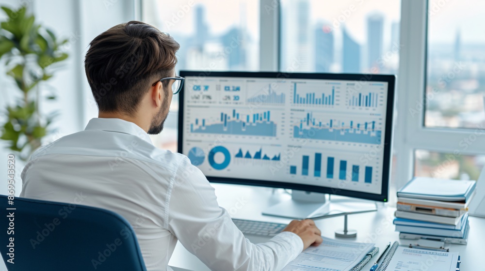 Businessman Analyzing Data on Computer Monitor.