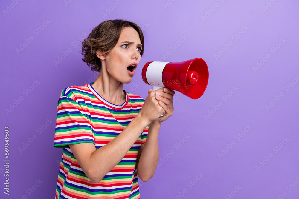 Photo of disappointed angry girl speaking bullhorn watching empty space banner news isolated on purple color background Photo of disappointed angry girl speaking bullhorn watching empty space banner news isolated on purple color background