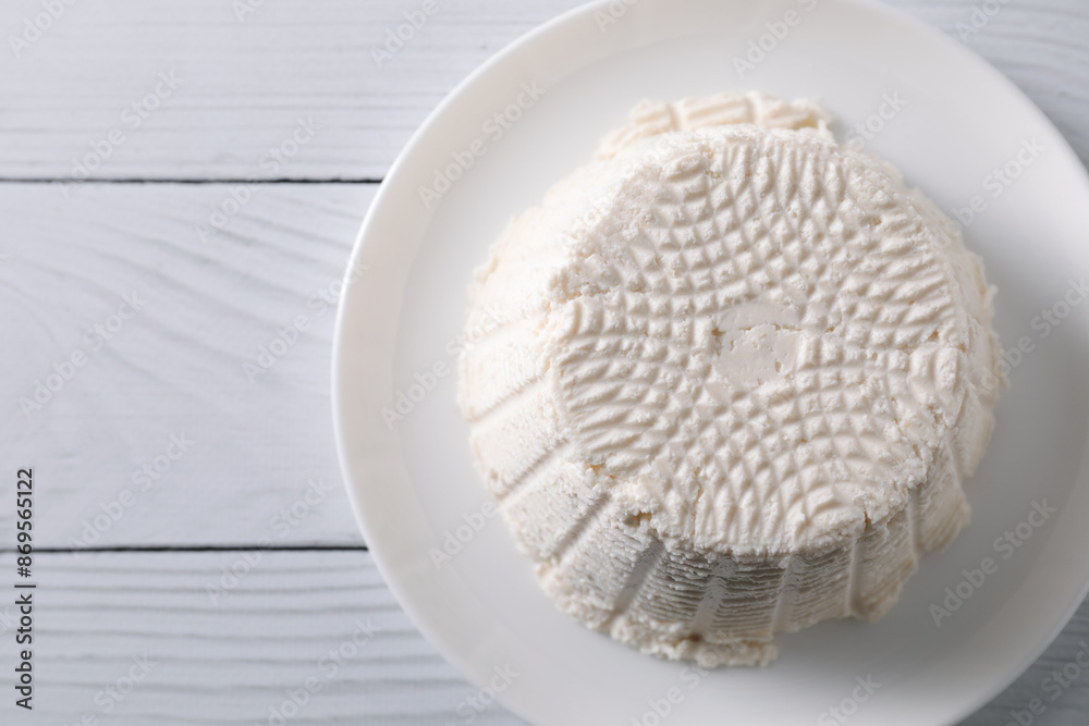 Fresh ricotta (cream cheese) on white wooden table, top view. Space for text Fresh ricotta (cream cheese) on white wooden table, top view. Space for text