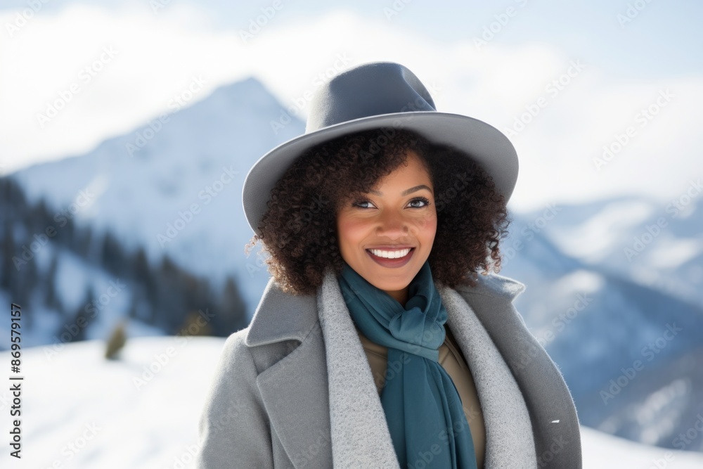 Portrait of a cheerful afro-american woman in her 30s donning a classic fedora in pristine snowy mountain Portrait of a cheerful afro-american woman in her 30s donning a classic fedora in pristine snowy mountain