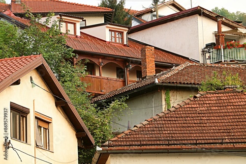 Houses with tiled roofs stand close together on a hillside 