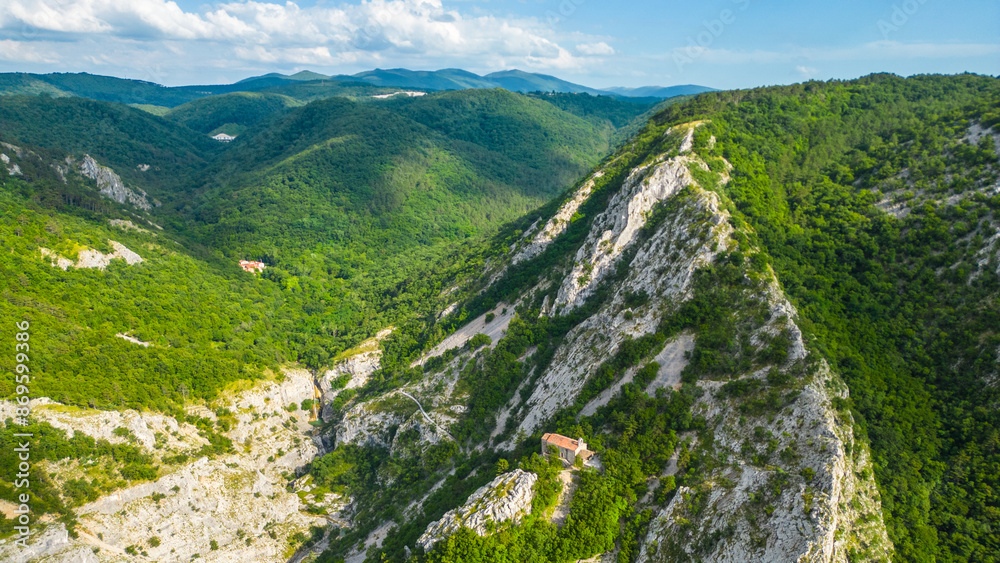 An aerial view of the stunning Val Rosandra Nature Reserve, showcasing its beautiful hiking trails that wind through lush greenery and rugged landscapes. Located near Trieste, Italy An aerial view of the stunning Val Rosandra Nature Reserve, showcasing its beautiful hiking trails that wind through lush greenery and rugged landscapes. Located near Trieste, Italy