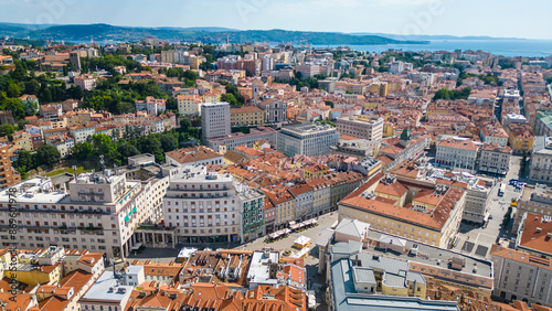 An impressive aerial shot of Trieste, Italy, featuring a majestic cruise ship docked at the port. This vibrant city, known for its rich history, stunning architecture, and bustling waterfront photo