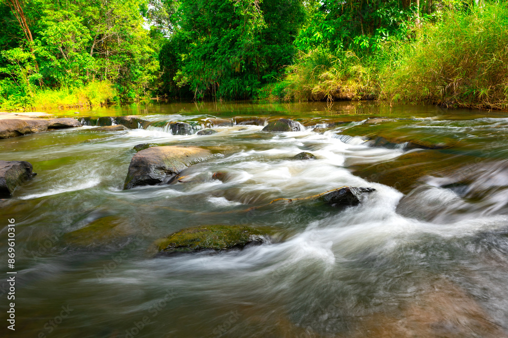 Beautiful waterfall, violent stream in the deep forest of the border of Thailand and Cambodia,Wang Yai waterfall in tropical forest,Sisaket province,Thailand. Leaf moving low Beautiful waterfall, violent stream in the deep forest of the border of Thailand and Cambodia,Wang Yai waterfall in tropical forest,Sisaket province,Thailand. Leaf moving low