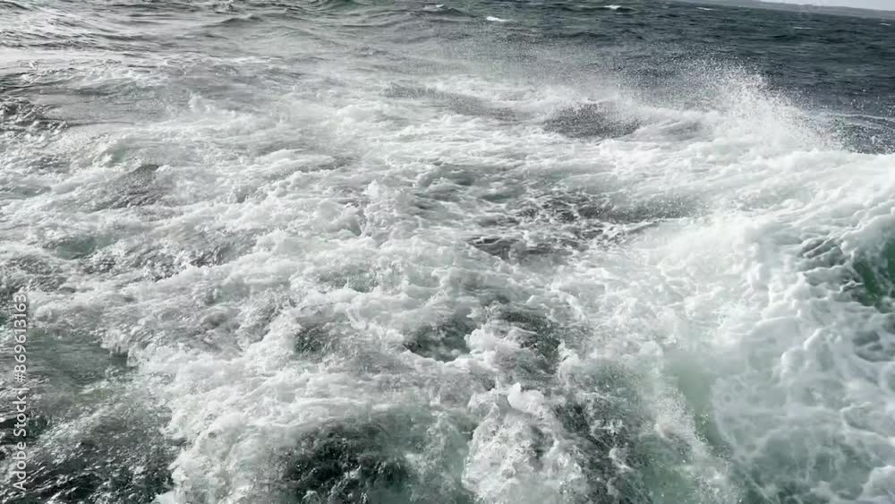 Wild swell in the sea during a storm, water droplets and splashes foam in the waves.