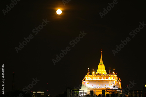 Fantastic Light-up Phu Khao Thong Stupa or Golden Mount of Wat Saket Temple on the Amazing Full Moon Night in Bangkok, Thailand