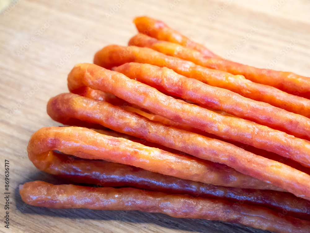The sausages’ glossy texture and the wooden backdrop imply a rustic dining concept. The sausages’ glossy texture and the wooden backdrop imply a rustic dining concept.