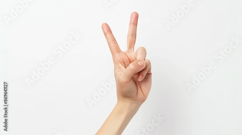 Woman's hand showing a peace sign, white background © chanidapa