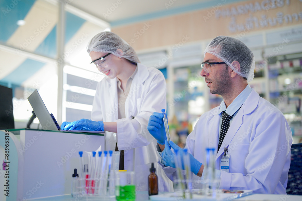 scientists perform experiments and record data. people arranges equipment with test tubes and chemicals for producing medicine and biochemistry. man hold tubes of chemical liquids and plant samples. scientists perform experiments and record data. people arranges equipment with test tubes and chemicals for producing medicine and biochemistry. man hold tubes of chemical liquids and plant samples.