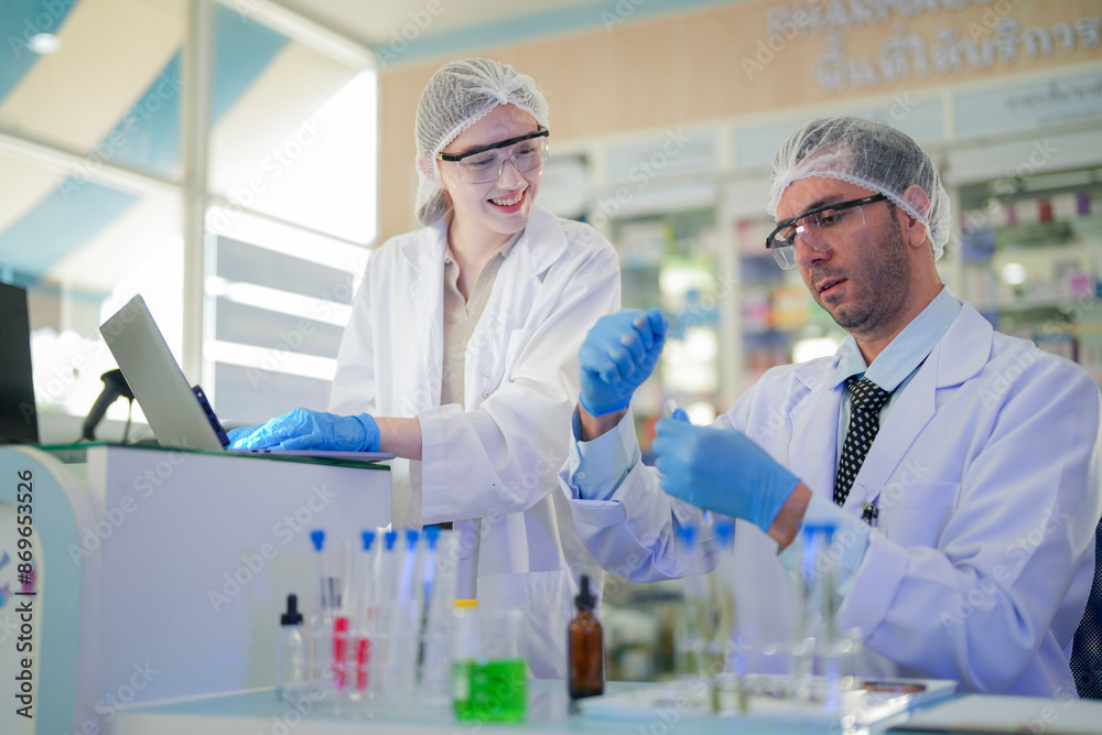 scientists perform experiments and record data. people arranges equipment with test tubes and chemicals for producing medicine and biochemistry. man hold tubes of chemical liquids and plant samples. scientists perform experiments and record data. people arranges equipment with test tubes and chemicals for producing medicine and biochemistry. man hold tubes of chemical liquids and plant samples.