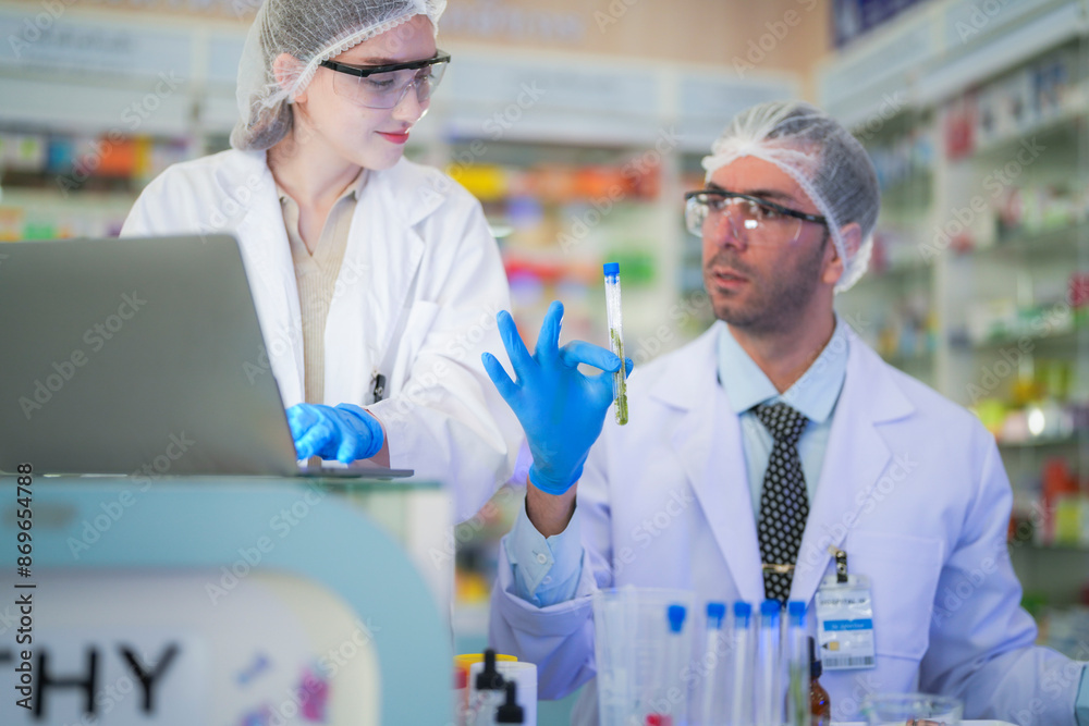 scientists perform experiments and record data. people arranges equipment with test tubes and chemicals for producing medicine and biochemistry. man hold tubes of chemical liquids and plant samples. scientists perform experiments and record data. people arranges equipment with test tubes and chemicals for producing medicine and biochemistry. man hold tubes of chemical liquids and plant samples.