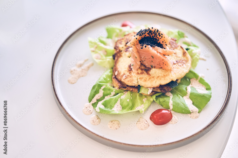 Breakfast of potato pancakes with lightly salted salmon, herbs and cream sauce top view. Delicious vegetable pancakes with salmon on a plate with space to copy. High quality photo Breakfast of potato pancakes with lightly salted salmon, herbs and cream sauce top view. Delicious vegetable pancakes with salmon on a plate with space to copy. High quality photo