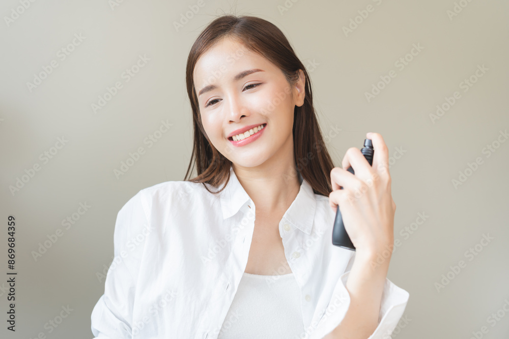 Perfume of essential aroma, beauty fashion concept. attractive perfect asian young woman hand holding perfume bottle, using spray and applying fragrance, scent at neck on body, isolated on background. Perfume of essential aroma, beauty fashion concept. attractive perfect asian young woman hand holding perfume bottle, using spray and applying fragrance, scent at neck on body, isolated on background.