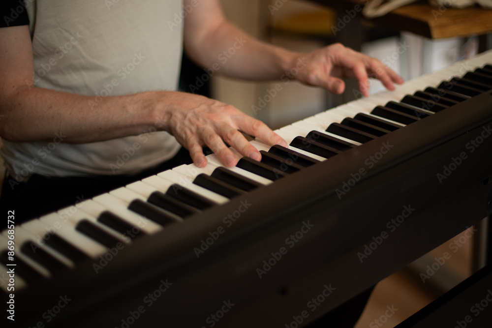 Obraz premium Close-up of Hands Playing an Electric Piano