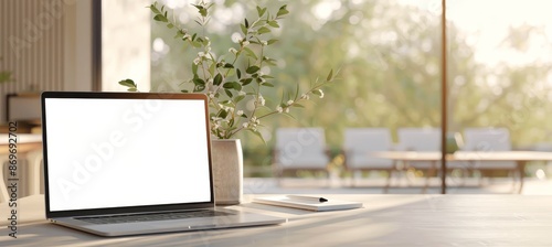 A laptop is open on a table with a vase of flowers next to it by AI generated image