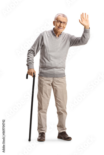 Happy elderly man with a walking cane waving