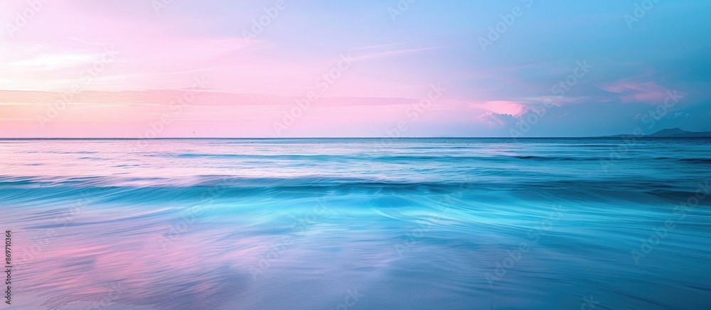 Seascape with a serene beach at sunset. The horizon filled with a blend of blue and pink hues, creating a tranquil setting for the copy space image. Seascape with a serene beach at sunset. The horizon filled with a blend of blue and pink hues, creating a tranquil setting for the copy space image.