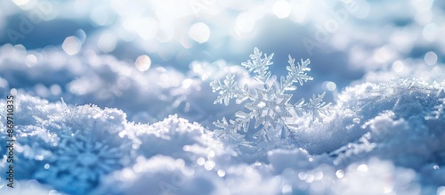 Snowflakes on a snow-covered background with copy space image. © HN Works