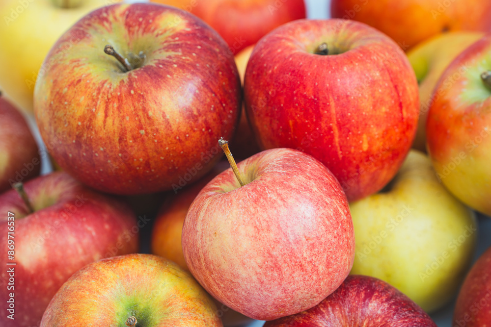 fresh apples, showcasing their vibrant red and yellow skins. The apples are arranged closely together, highlighting their crisp texture and natural appeal fresh apples, showcasing their vibrant red and yellow skins. The apples are arranged closely together, highlighting their crisp texture and natural appeal