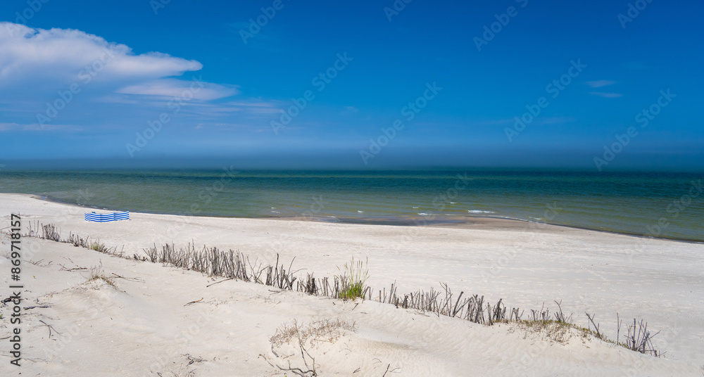 view on sandy beach on Baltic sea in Poland during sunny day