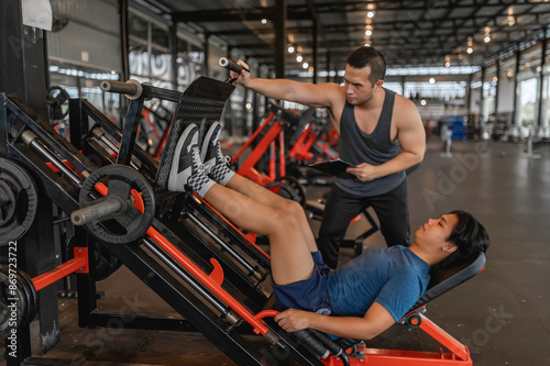 Asian man sitting on a stool with personal trainer,Hire a professional trainer to teach weight training,body and healthy cardio sports workout