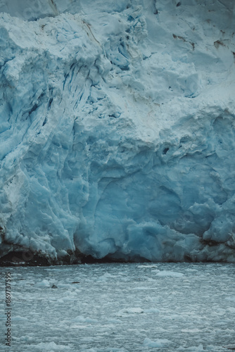 Antarctica Glacier Frozen Ice Close Up Nature Details. Icebergs Scattered in the Water Below View From Boat. Climate Change Global Warming.