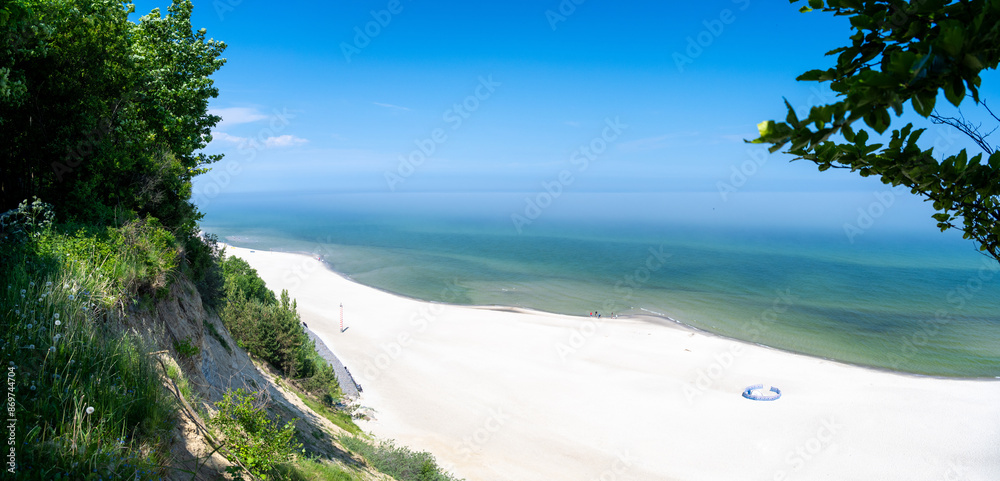 view on sandy beach on Baltic sea in Poland during sunny day