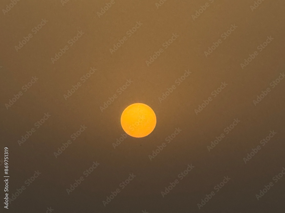 sun looking like a bright yellow dot sun looking like a bright yellow dot