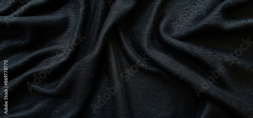 Luxurious black satin fabric texture with elegant ripples photo