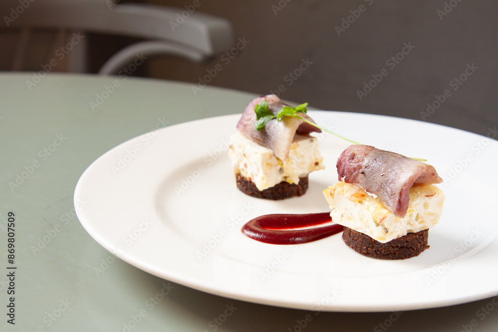 Gourmet pickled herring appetizer at fine dining Polish restaurant Gourmet pickled herring appetizer at fine dining Polish restaurant