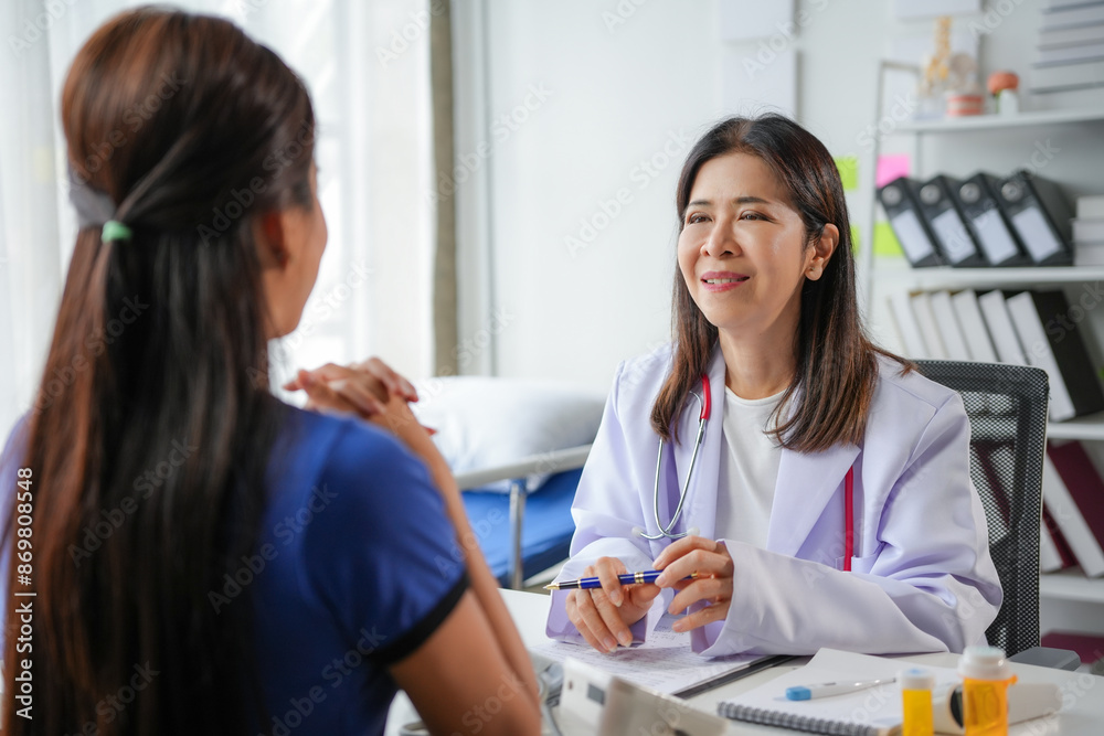Senior female doctor comforting patient during medical consultation Senior female doctor comforting patient during medical consultation