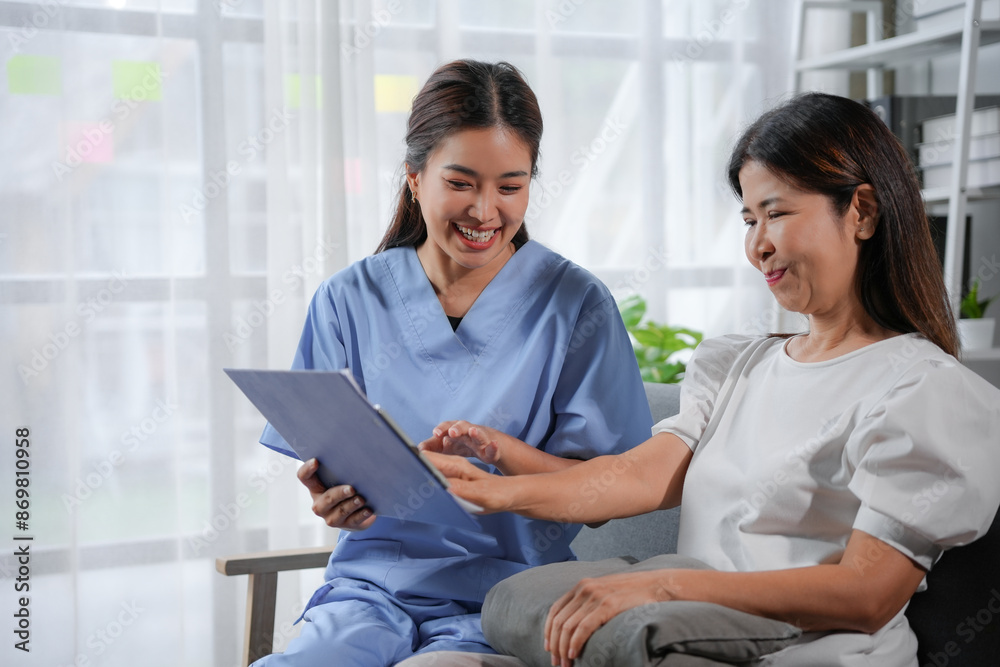Smiling nurse showing medical test results on clipboard to happy senior patient Smiling nurse showing medical test results on clipboard to happy senior patient