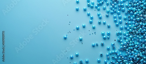 Top view of a blue background adorned with circular blue beads, creating a copy space image. photo