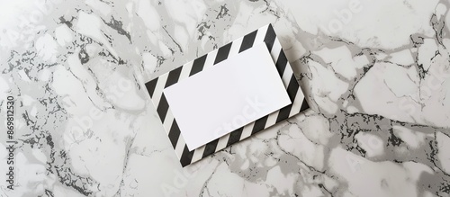 Top view of a striped employee badge and postcard arranged on a marble surface for a mockup with copy space image. photo