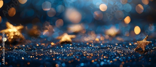 Shiny golden stars on navy blue background. Holiday confetti on New Year's Eve bokeh wallpaper, Christmas, beautiful wallpaper.