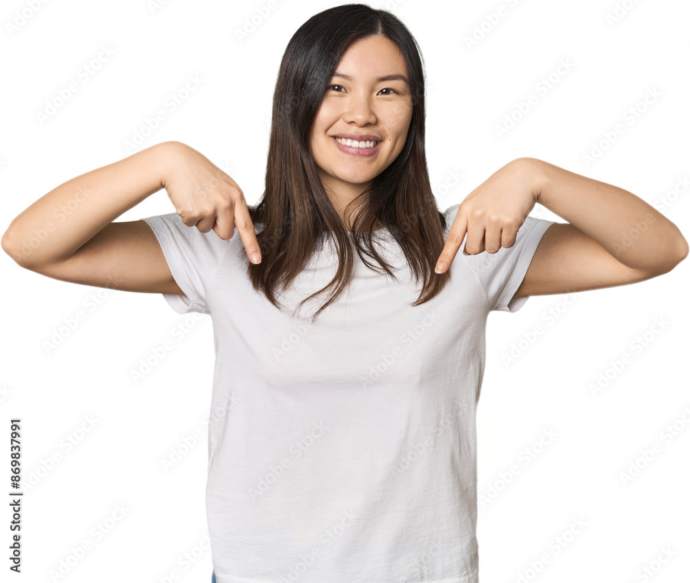Fototapeta premium Young Chinese woman points down with fingers, positive feeling.