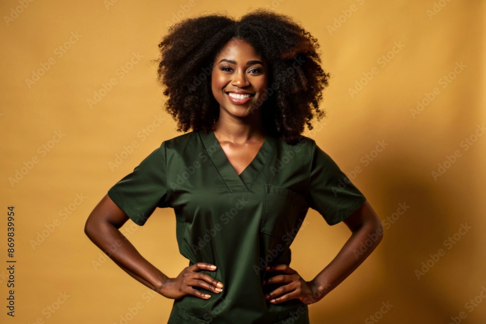 smiling woman in green medical uniform, standing with her hands on her hips smiling woman in green medical uniform, standing with her hands on her hips