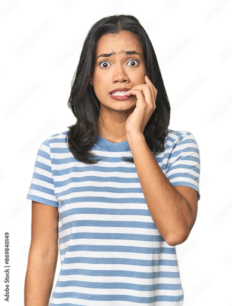 Young Latina posing in studio biting fingernails, nervous and very anxious. Young Latina posing in studio biting fingernails, nervous and very anxious.