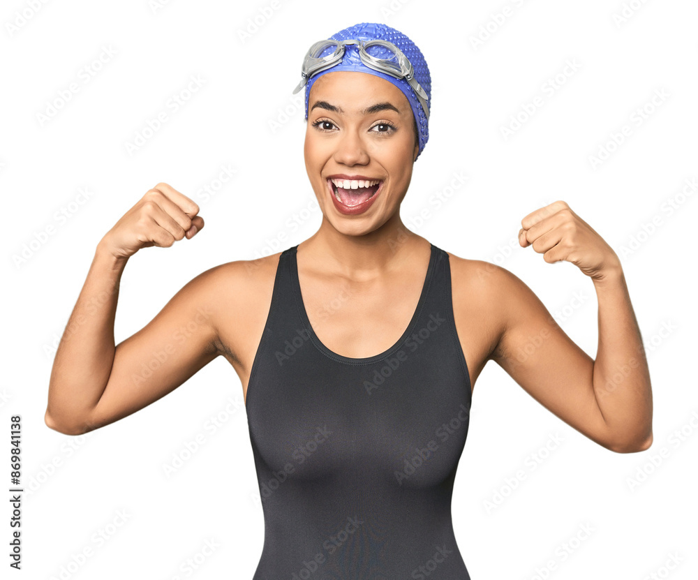 Pro Latina swimmer in studio gear showing strength gesture with arms, symbol of feminine power Pro Latina swimmer in studio gear showing strength gesture with arms, symbol of feminine power