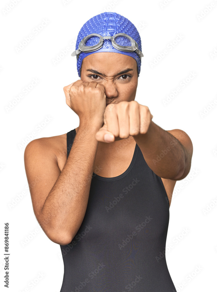 Fototapeta premium Pro Latina swimmer in studio gear throwing a punch, anger, fighting due to an argument, boxing.
