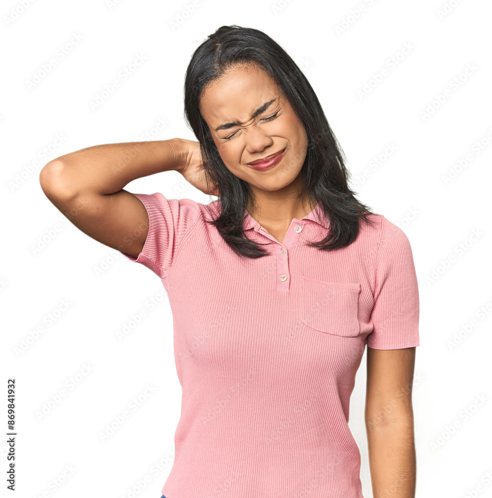 Simple portrait of a young Latina suffering neck pain due to sedentary lifestyle. Simple portrait of a young Latina suffering neck pain due to sedentary lifestyle.