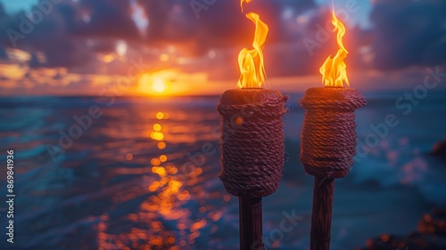 Two Tiki Torches with Bright Flames Set Against a Stunning Oceanview Sunset with Vibrant Colors and Dramatic Sky Over the WaterTiki torch