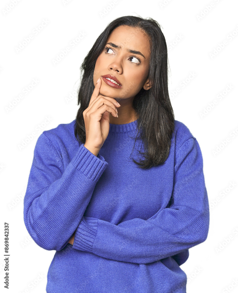 © Asier - Simple portrait of a young Latina looking sideways with doubtful and skeptical expression.