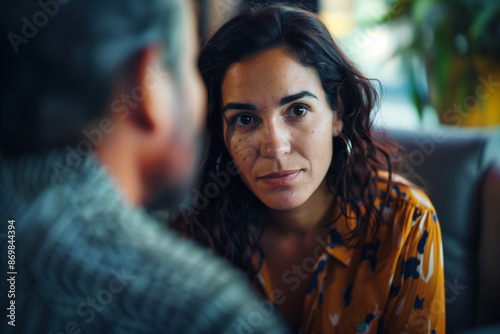 closeup portrait-style photo showing a counselor leaning slightly forward, attentively listening to their patient. The counselor's expression is one of deep empathy and understandi