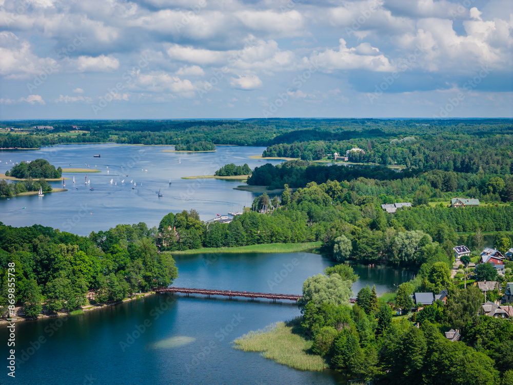 Aerial view of Trakai town and its surroundings, located on Galve lake, Lithuania. Beautiful view of bridge in lake from drone in summer