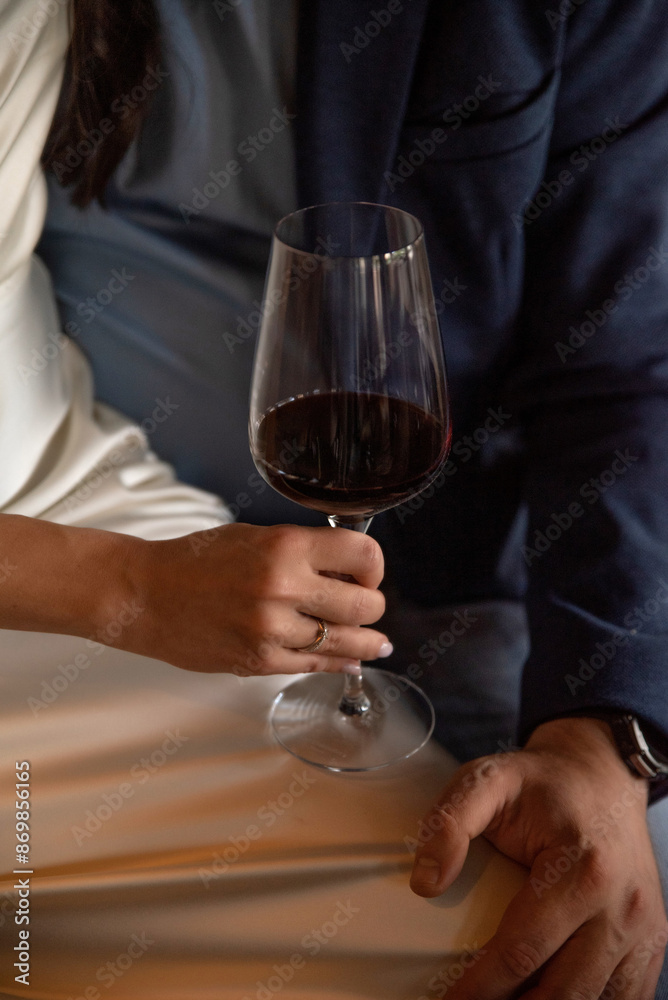 Woman's hand holding a glass of red wine close-up Woman's hand holding a glass of red wine close-up