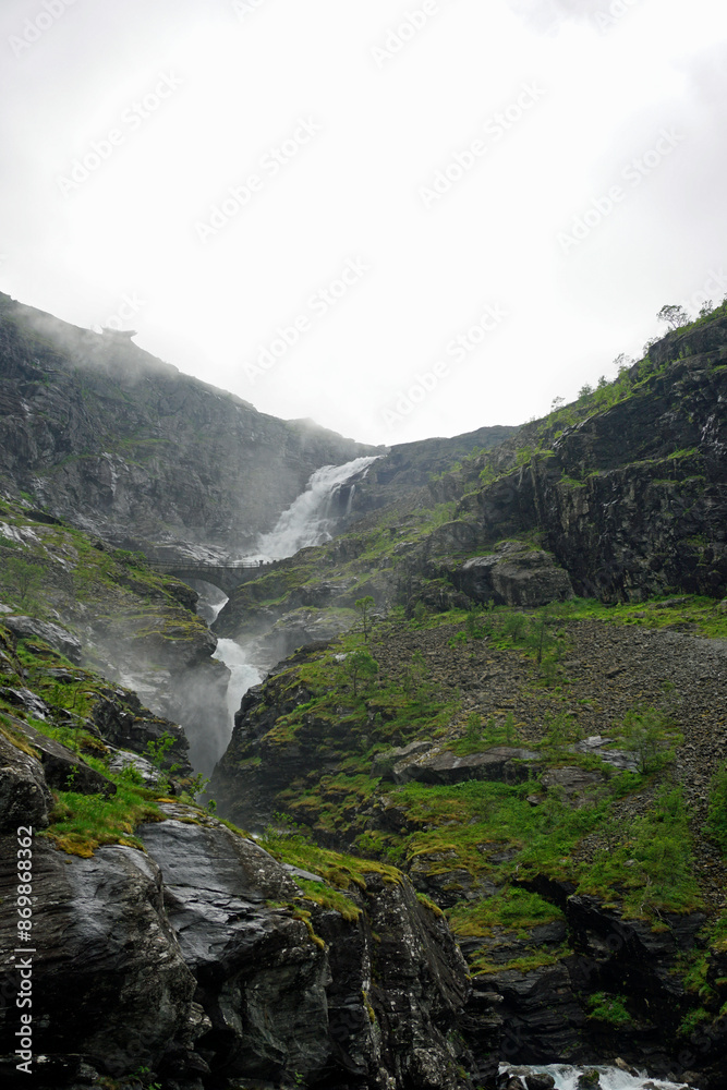 Nature and landscapes of Norway. Waterfall on the troll road. Cloudy day and clouds on top of a mountain. Nature and landscapes of Norway. Waterfall on the troll road. Cloudy day and clouds on top of a mountain.